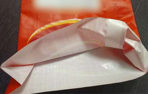 Easy-open tape sewn across the end of a bag